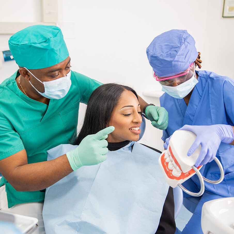 A dentist gives a consultation to a patient and with his assistant they explain the teeth